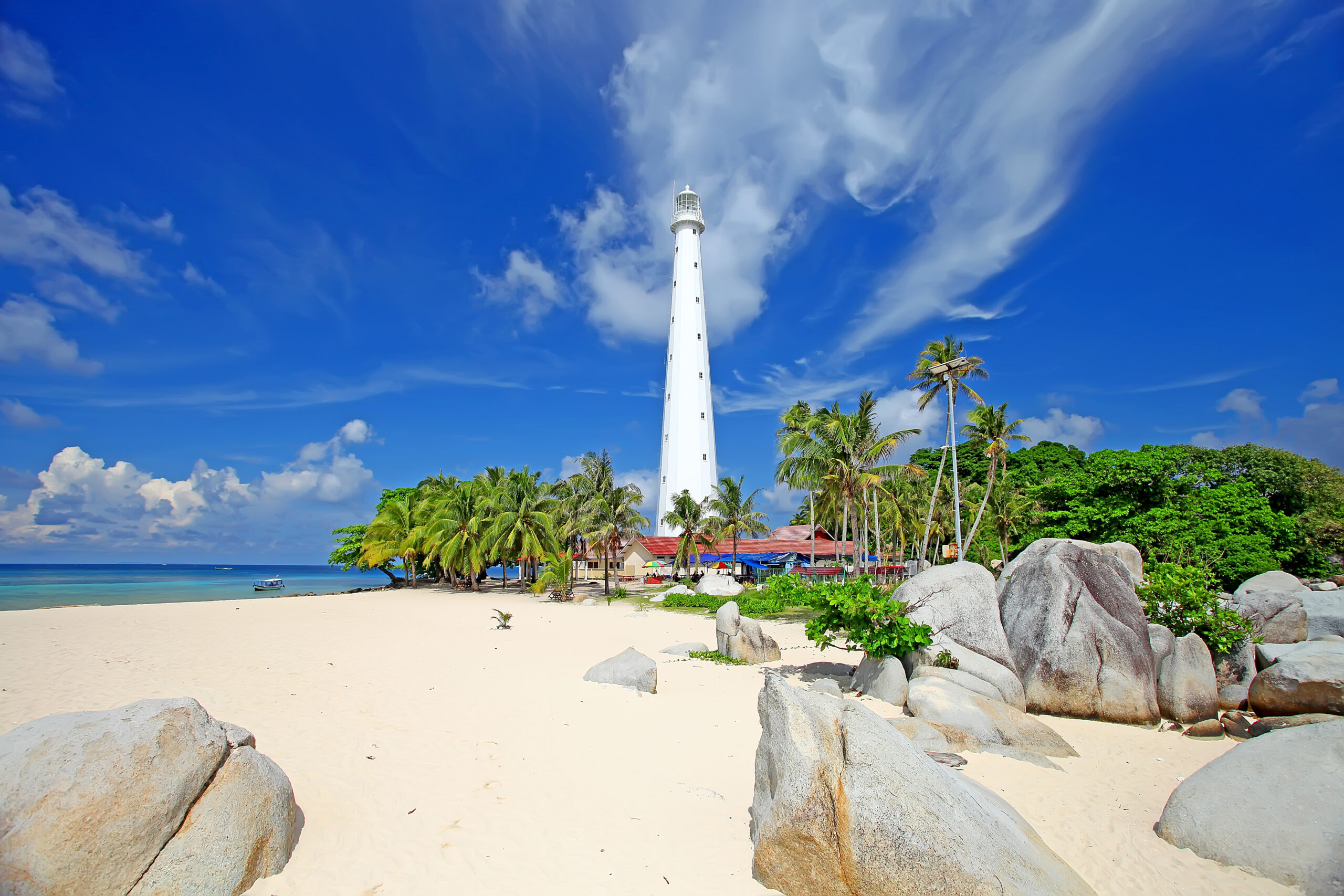 Tiny Indonesian tropical islands located off the northeast corner of Belitung Island in Sumatra, Indonesia with white sand beaches, coconut trees and clear turquoise waters.